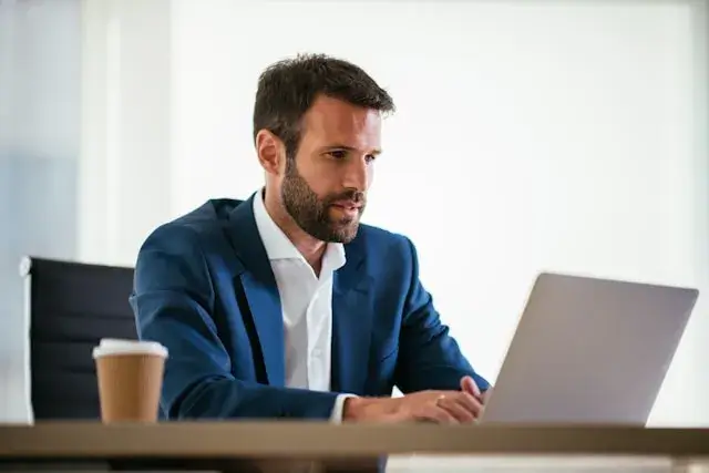 Successful executive focused on work in corner office representing the 80% of passive talent not actively seeking new opportunities